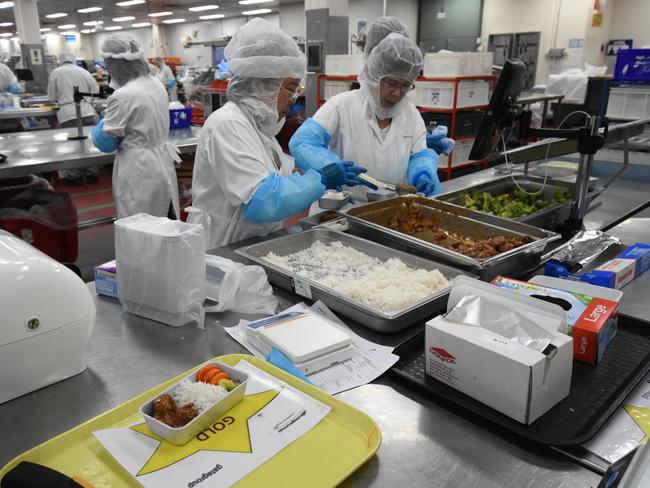 Workers prepare meals for Singapore Airlines. Picture: Simon Tsang