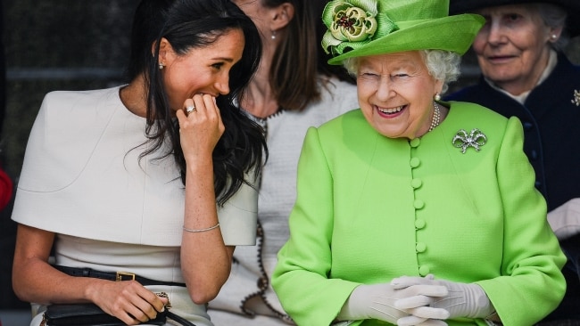 Queen Elizabeth II sits and laughs with Meghan, Duchess of Sussex during a ceremony to open the new Mersey Gateway Bridge on June 14, 2018 in the town of Widnes in Halton, Cheshire, England. (Photo by Jeff J Mitchell/Getty Images)