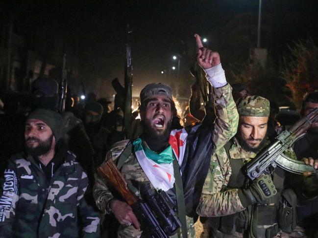 Islamist-led Syrian rebel fighters celebrate in the streets of Homs in the early hours of December 8, after entering Syria's third city overnight. Picture: Abdulaziz Ketaz/AFP