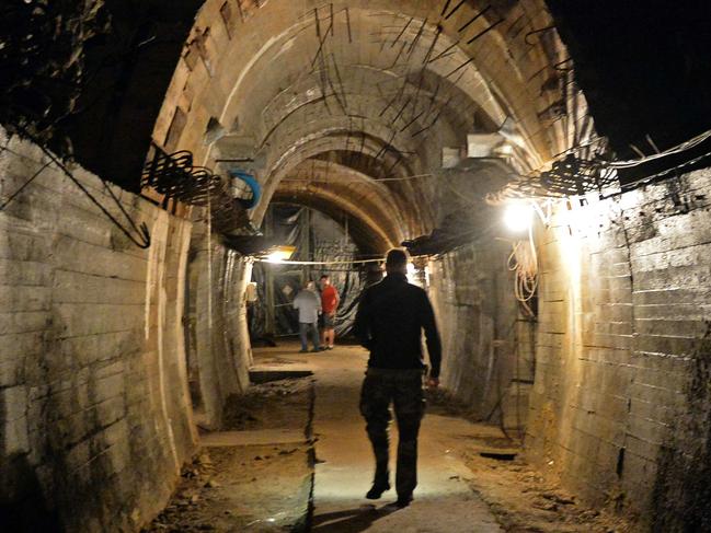 TOPSHOTS Men walk in underground galeries, part of Nazi Germany "Riese" construction project under the Ksiaz castle in the area where the "Nazi gold train" is supposedly hidden underground, on August 28, 2015 in Walbrzych, Poland. Poland's deputy culture minister on Friday said he was 99 percent sure of the existence of the alleged Nazi train that has set off a gold rush in the country. AFP PHOTO / JANEK SKARZYNSKI