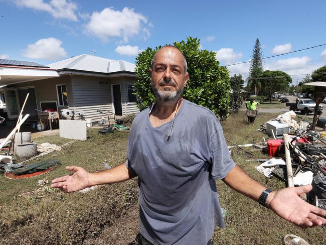 Manuel Halicos emptying and cleaning his flooded house in Fairfield on March 2. Picture: Liam Kidston.