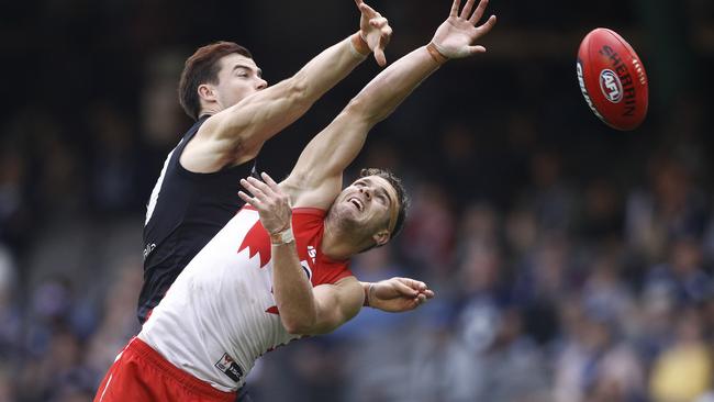 Tom Papley rises in a marking contest against Lachie Plowman on Saturday. Picture: AAP Image/Daniel Pockett.