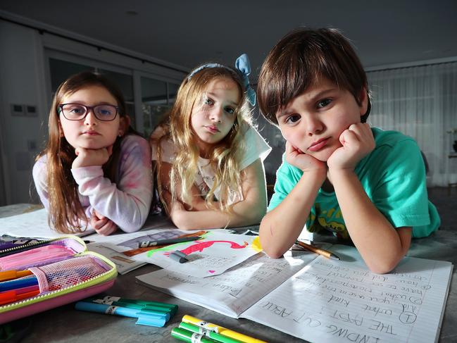 MELBOURNE- Kids sick of homeschooling. L-R Olivia 7, Annalise 9 and George 5 are sick of learning from home. At their house in Ivahoe.  Picture Rebecca Michael.