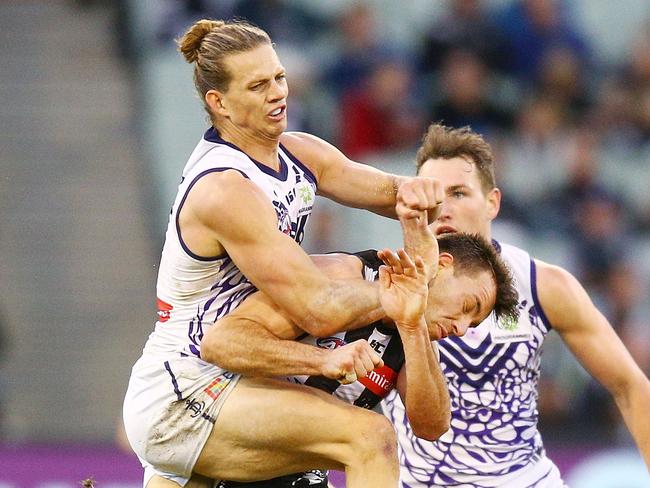 MELBOURNE, AUSTRALIA - JUNE 03: Nat Fyfe of the Dockers hits Levi Greenwood of the Magpies high in a late contest for the ball during the round 11 AFL match between the Collingwood Magpies and the Fremantle Dockers at Melbourne Cricket Ground on June 3, 2018 in Melbourne, Australia.  (Photo by Michael Dodge/Getty Images)