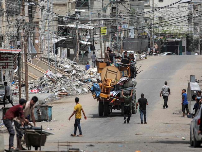 Men ride in the back of a truck loaded with furniture and other items as they flee Rafah in the southern Gaza Strip. Picture: AFP