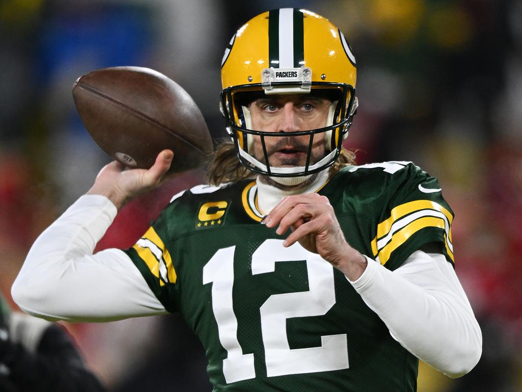 Aaron Rodgers of the Green Bay Packers wears a coat to stay warm in News  Photo - Getty Images