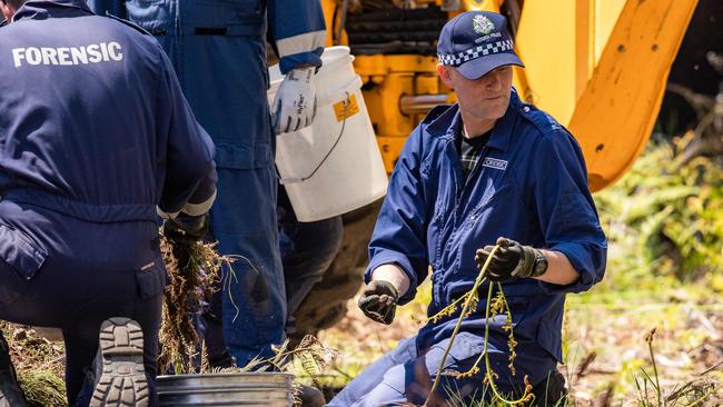 Forensics officers sift through dirt, rocks and vegetation. Picture: Jason Edwards