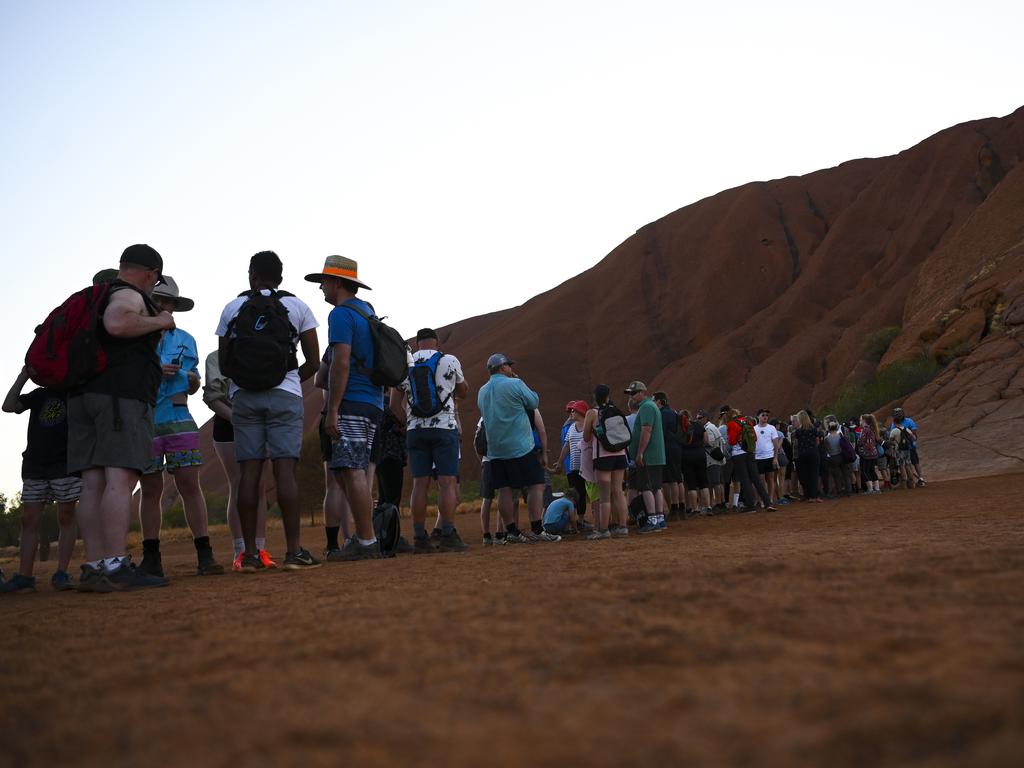 Tourists are seen lining up to climb Uluru, at Uluru-Kata Tjuta National Park in the Northern Territory on October 12. Picture: Lukas Coch/AAP