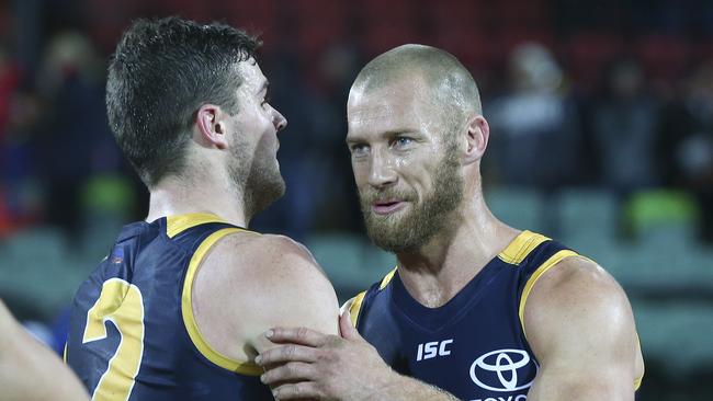 Scott Thompson and Brad Crouch after Thompson’s last AFL game in 2017. Picture: Sarah Reed.