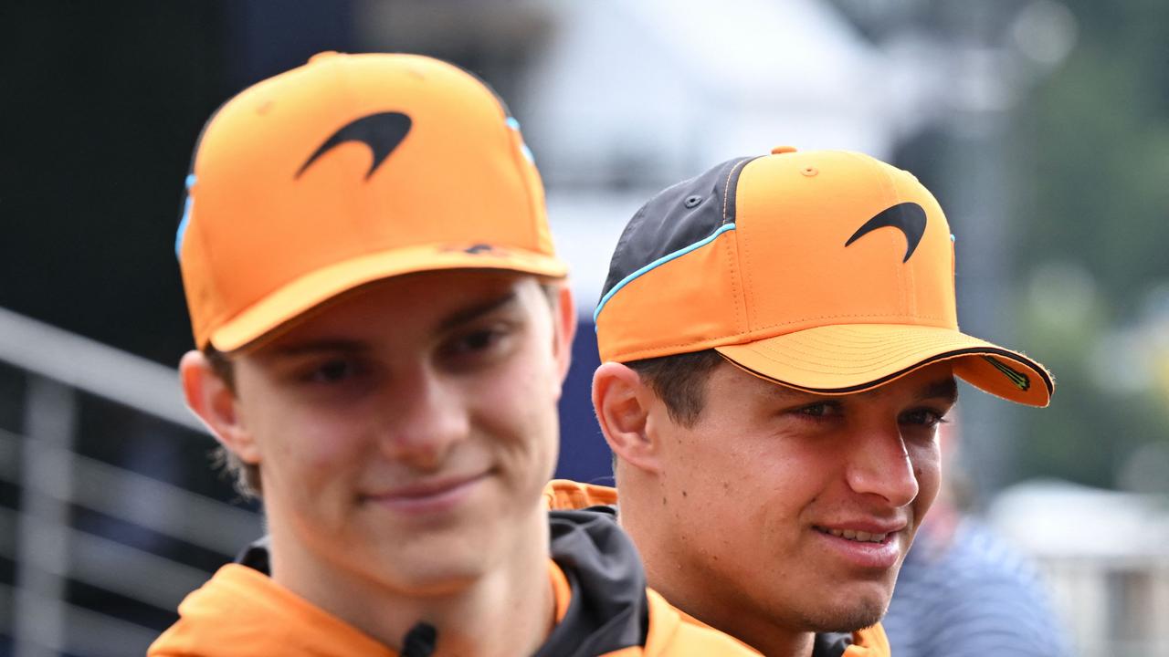 McLaren's Australian driver Oscar Piastri (L) and McLaren's British driver Lando Norris look on as they walk in the paddock ahead of the Formula One Belgian Grand Prix at the Spa-Francorchamps circuit in Spa on July 26, 2024 (Photo by JOHN THYS / AFP)