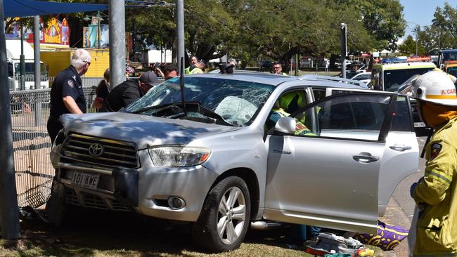 Emergency crews were forced to work to free a woman trapped in the driver’s seat of her SUV vehicle after an apparent collision with a truck sent her vehicle careening off the Bruce Highway and into a children’s playground in the centre of Ingham. Picture: CAMERON BATES