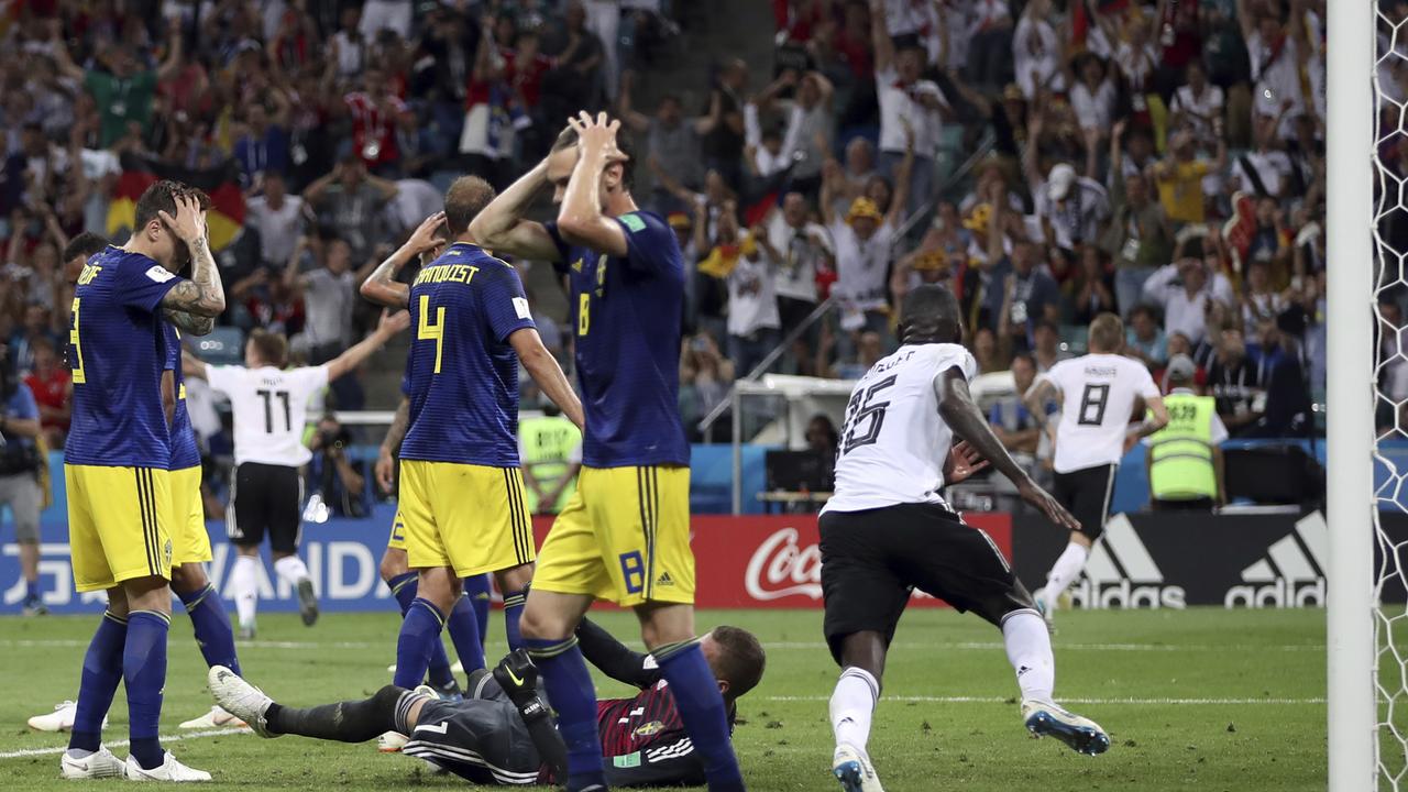 Sweden players reacts after Germany's Toni Kroos, right, scores his side's second goal