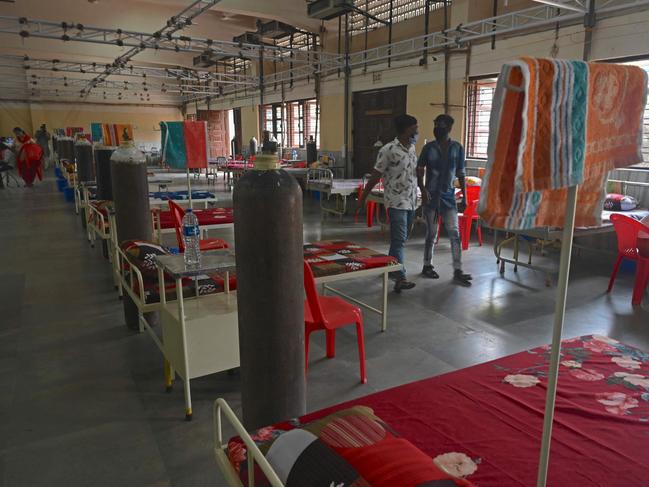 Staff walk past the rows of beds at a newly set up COVID care centre in Mumbai. Picture: AFP