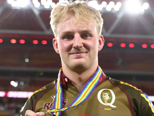 BRISBANE, AUSTRALIA - APRIL 25:  Tom Lynagh of the Reds hold the ANZAC medal after the round 11 Super Rugby Pacific match between Queensland Reds and Blues at Suncorp Stadium, on April 25, 2025, in Brisbane, Australia. (Photo by Chris Hyde/Getty Images)
