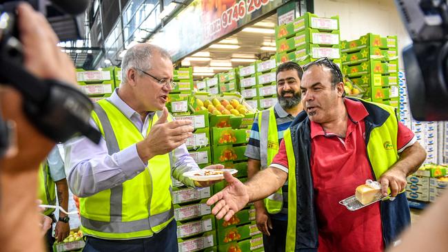 Federal Treasurer Scott Morrison visits the Sydney Markets in Homebush after handing down the mid year budget update yesterday. Picture: AAP