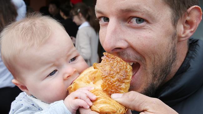 Marcus Hamilton and his daughter Frankie tuck into a croissant. Picture: Ian Currie