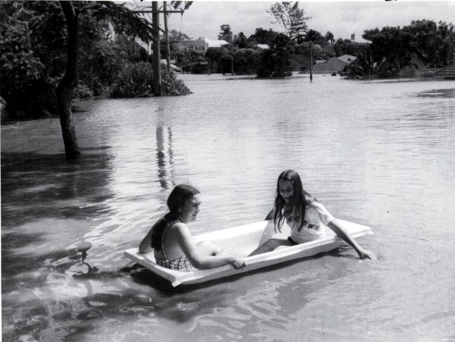 Yeronga West, one of the hardest hit suburbs of Brisbane had it lighter moments when these two floodbound residents moved around in a floating bathtub.