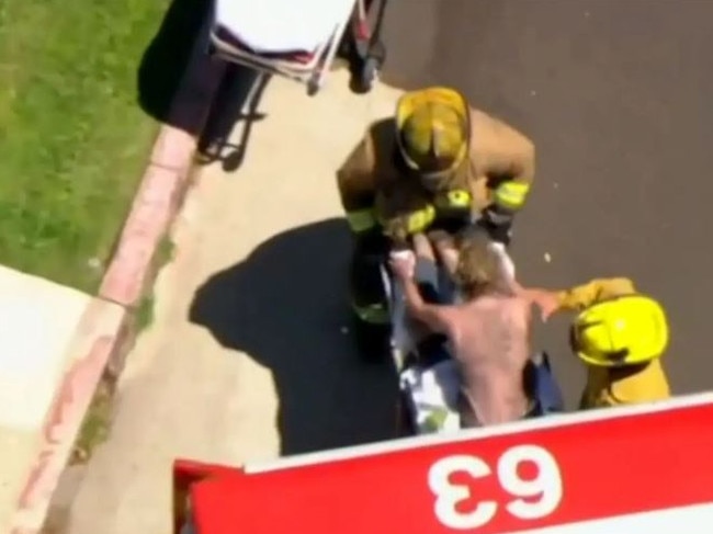 An injured Heche is taken into the ambulance. Picture: Fox 11