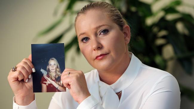 Virginia Giuffre holds a photo of herself at age 16, when she says Palm Beach multi-millionaire Jeffrey Epstein began abusing her. Picture: Getty