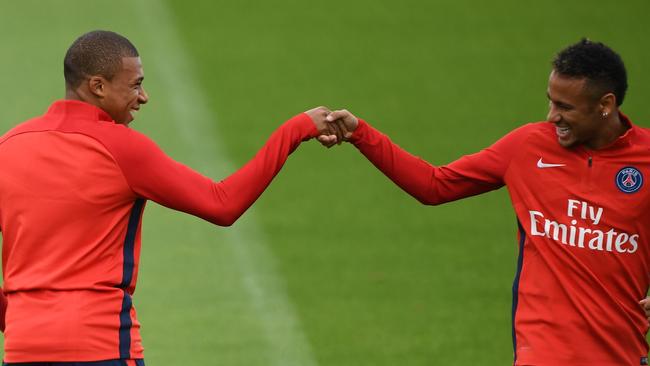 Paris Saint-Germain's French forward Kylian Mbappe (L) and PSG’s Brazilian forward Neymar shake hands.