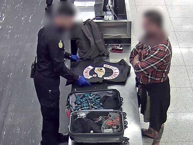 The French Hells Angel bikie being questioned by an Australian Border Force  officer at Perth Airport.