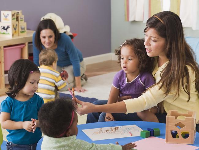 Teachers and toddlers in daycare.Preschool, Nursery School Building, Child, Child Care, Education, Teacher, Toddler, Learning, Messing About, Playing, Teaching, Childhood, Boys, Assistance, Latin American and Hispanic, Table, Toy, Group Of People,  Fun, Multiracial Group, Friendship, Girls, People, Adult, Indoors, Occupation, 18-23 Months, 25-29 Years, 30-39 Years, African-American Ethnicity, Asian, Blonde Hair, Brown Hair, Caucasian Appearance, Cheerful, Colour Image, Colouring, Crayon, Cute, Daycare, Filipino, Growth, Horizontal, Large Group Of People, Latin, Thinkstock, Generic, Childcare