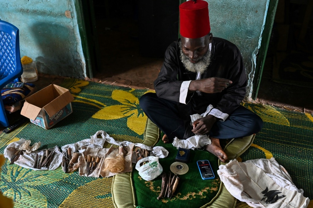 Mory Bamba, a Muslim leader who fights FGM in Ivory Coast, with some of the blades used to cut girls