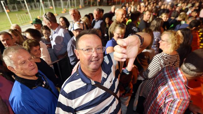 People queued at Pacific Fair interchange for transport to the opening ceremony at Metricon. Some had been there for 2 hours. Photo of David Stephenson from Melbourne. Photo: Richard Gosling