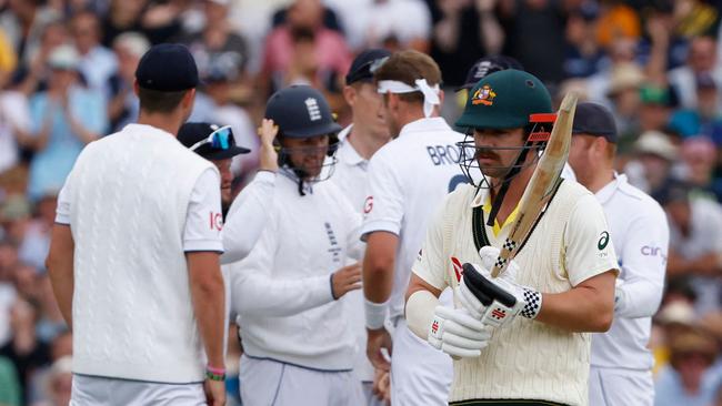 Australia's Travis Head (2R) walks back to the pavilion after falling to a Stuart Broad bouncer. Picture: AFP