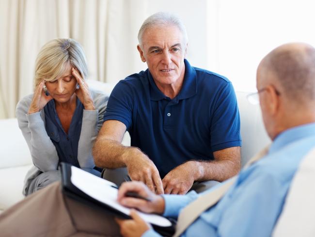 Senior couple clearing their doubts with the financial planner. financial advice, adviser, planner, stress, money generic