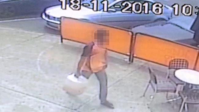 CCTV captures a man carrying a container shortly before the horrific fireball.