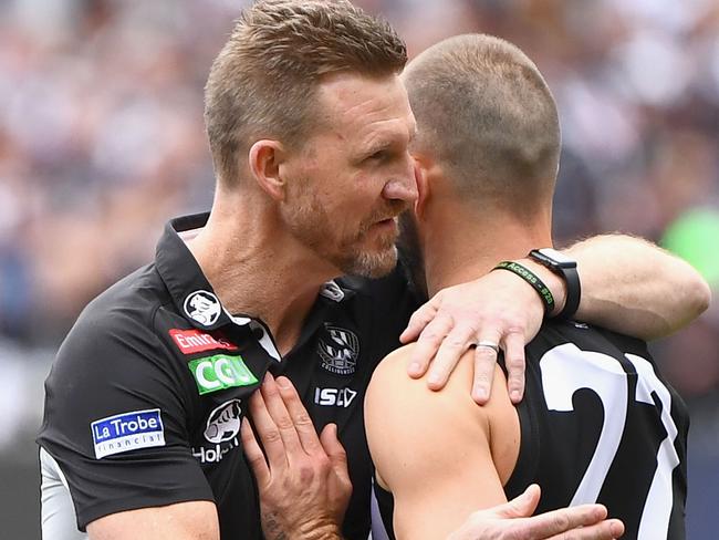 MELBOURNE, AUSTRALIA - SEPTEMBER 29: Magpies head coach Nathan Buckley hugs Steele Sidebottom  during the 2018 AFL Grand Final match between the Collingwood Magpies and the West Coast Eagles at Melbourne Cricket Ground on September 29, 2018 in Melbourne, Australia.  (Photo by Quinn Rooney/Getty Images)