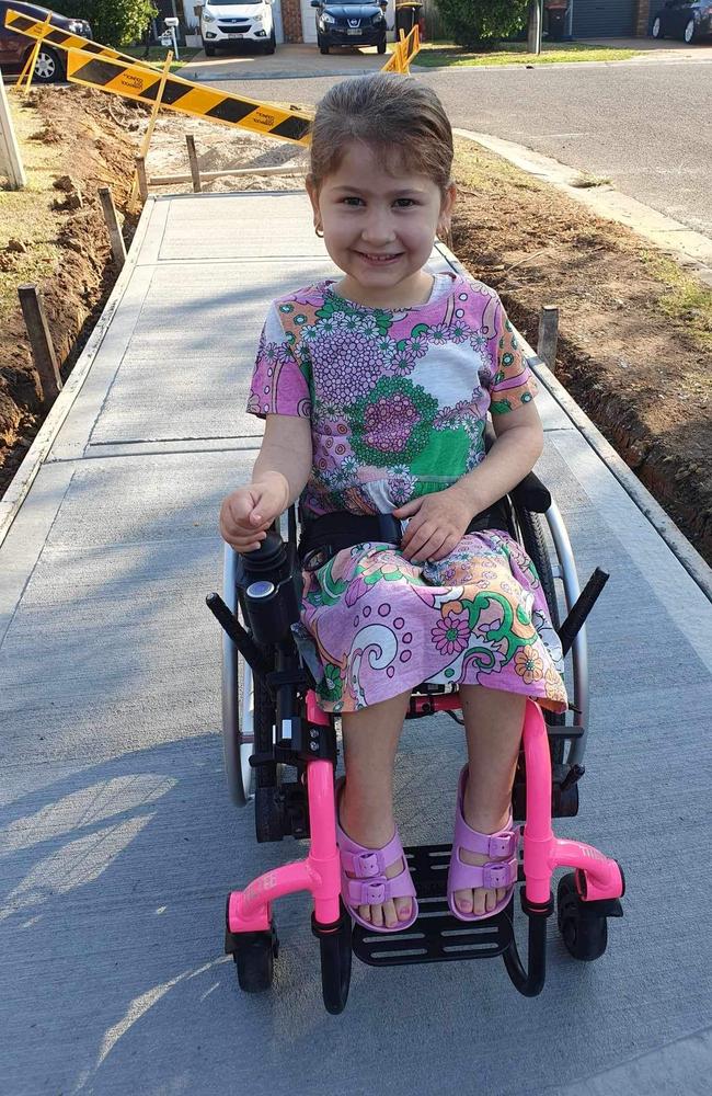 Leah Raish using the new pavement built outside her home in Wattle Grove. Picture: Supplied.