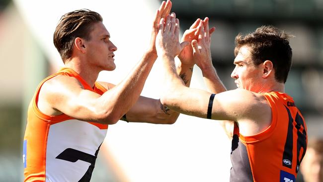 Rory Lobb and Jeremy Cameron celebrate a Giants goal.