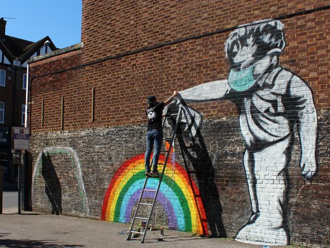 Street artist Chris Shea works on a mural in London. Picture: Getty Images