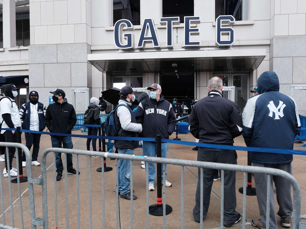 People line up to enter Yankee Stadium for opening day of the MLB season. President Joe Biden has urged clubs not to allow fans back at full capacity. Picture: Spencer Platt/Getty Images