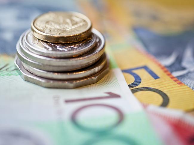 Stack of Australian dollars coins and notes