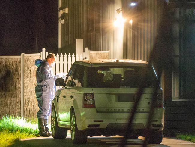 Police search a house where Darren Thornburgh’s body was found. Picture: Mark Stewart