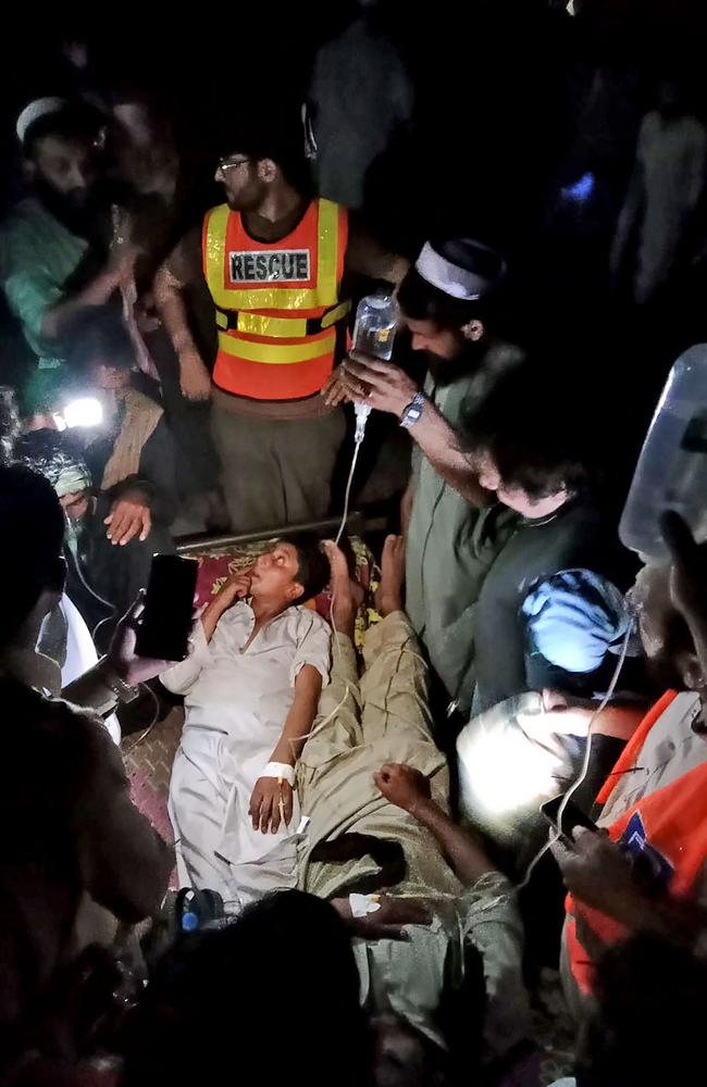 Victims receive first aid after being rescued. Picture: AFP