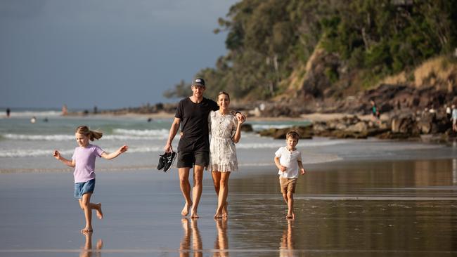 Tim and Bonnie Paine on the beach at Noosa with Milla and Charlie. Picture: David Kelly