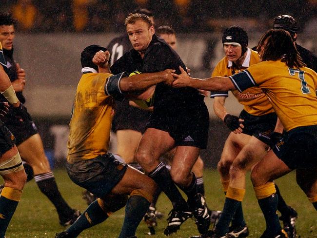 NEW ZEALAND - JULY 13: All Black Scott Robertson breaks through the Wallabies defence in the TriNations rugby match at Jade Stadium, Christchurch, Saturday. The All Blacks won 126. (Photo by Ross Land/Getty Images)