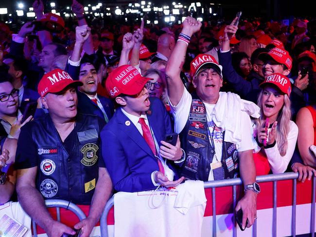 WEST PALM BEACH, FLORIDA - NOVEMBER 05: Supporters react while watching returns come in during an election night watch party for Republican presidential nominee, former U.S. President Donald Trump at the Palm Beach Convention Center on November 05, 2024 in West Palm Beach, Florida. Americans cast their ballots today in the presidential race between Republican nominee former President Donald Trump and Vice President Kamala Harris, as well as multiple state elections that will determine the balance of power in Congress.   Chip Somodevilla/Getty Images/AFP (Photo by CHIP SOMODEVILLA / GETTY IMAGES NORTH AMERICA / Getty Images via AFP)