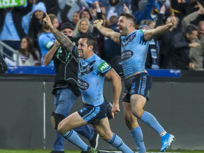 Mitchell Pearce of the Blues celebrates after James Tedesco of the Blues (behind) scored the match winner during Game 3 of the 2019 State of Origin series between the New South Wales Blues and the Queensland Maroons at ANZ Stadium in Sydney, Wednesday, July 10, 2019. (AAP Image/Craig Golding) NO ARCHIVING, EDITORIAL USE ONLY