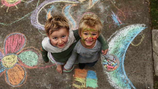 Eli O’Sullivan (left) and brother Beau enjoy painting, drawing with chalk and making things with playdoh at their Northern Beaches home. Picture: Toby Zerna