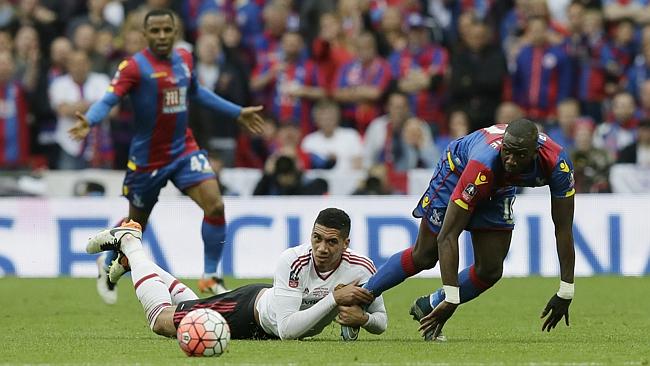 Manchester United’s Chris Smalling, left, holds the leg of Crystal Palace’s Yannick Bolasie.