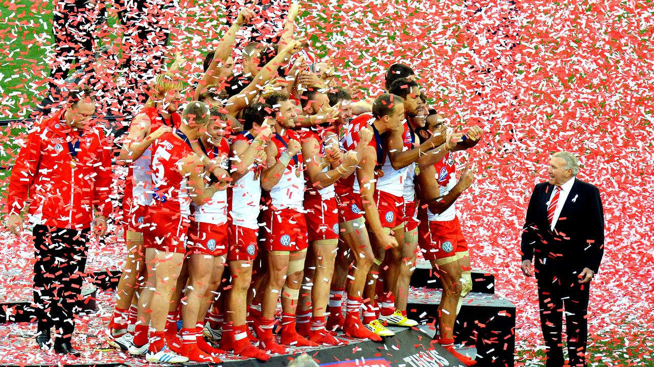 Sydney players on the podium after the 2012 grand final as Bob Skilton looks on.