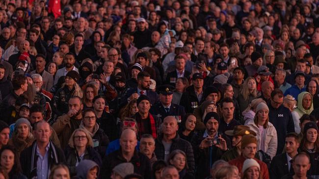 Crowds gather before dawn to pay tribute. Picture: Getty Images