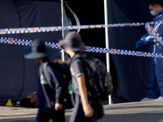 This photo of schoolkids looking on as Stemler’s dead body lay on the streets shocked the community at the time. Picture: NCA NewsWire