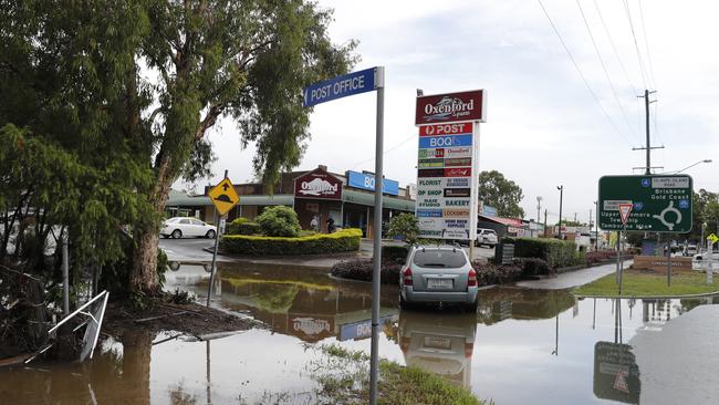 Flooding in front of Oxenford Square, Gold Coast, on Saturday, after a severe thunderstorm swept the coast during the early hours. Picture: AAP