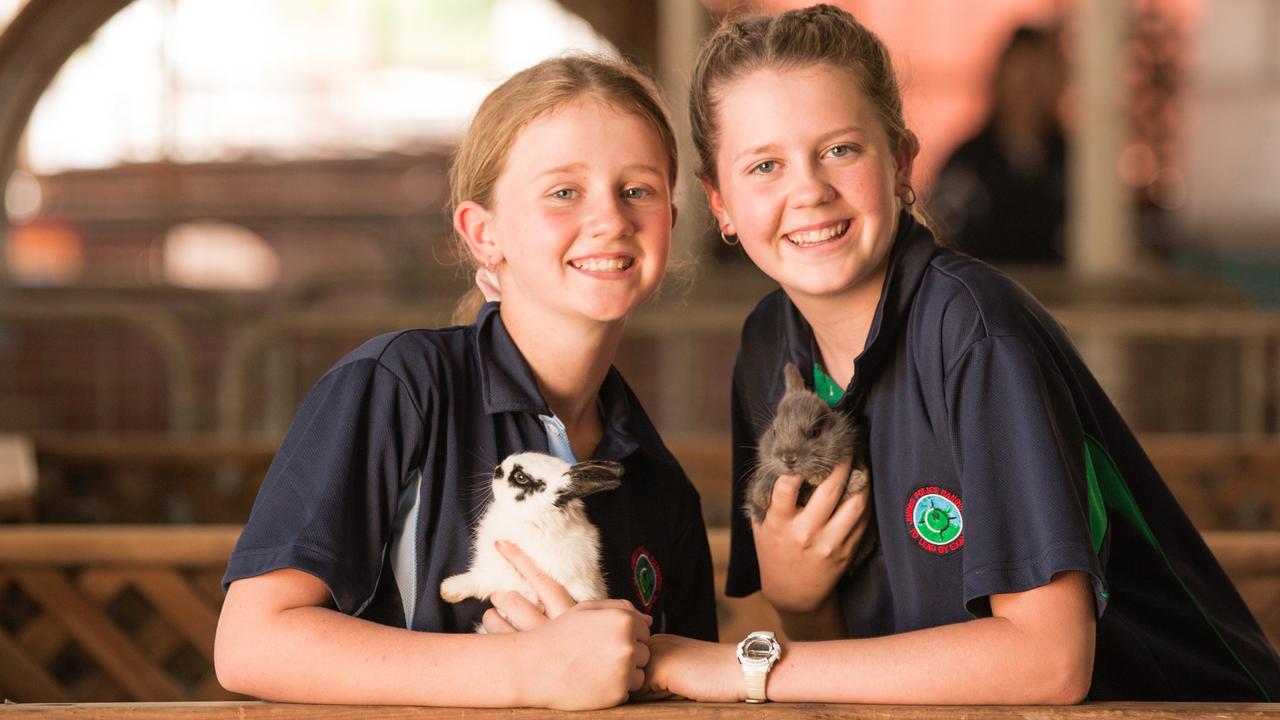 Inez, 12, and Severine Moir, 14, volunteering at the petting zoo. Pic Glenn Campbell